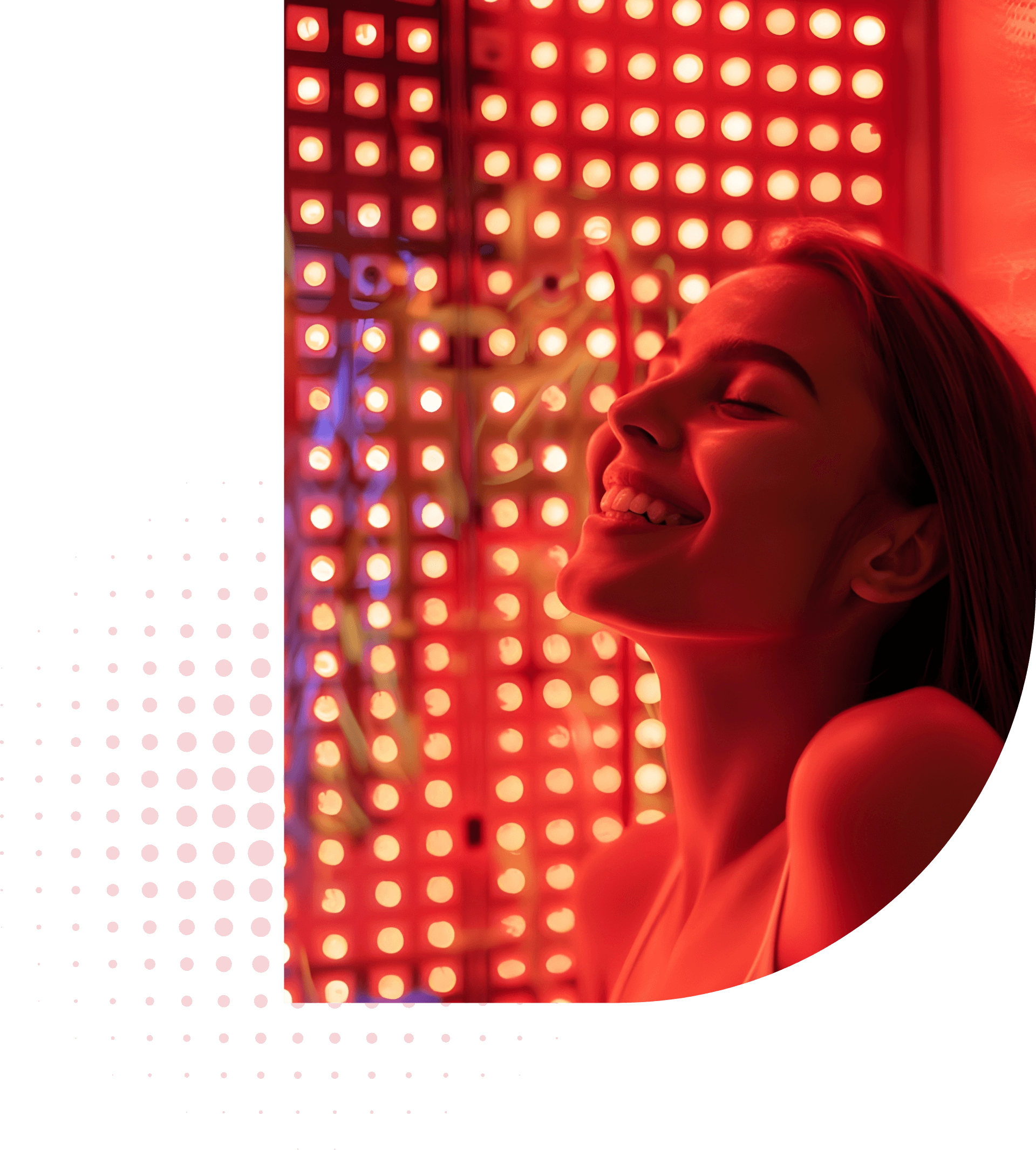 Smiling woman enjoying red light therapy session in front of glowing wellness panel at ReNuYou studio